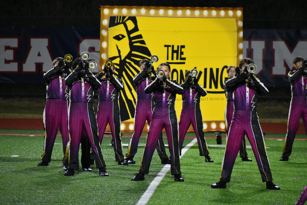 marching band students play trumpet during a performance